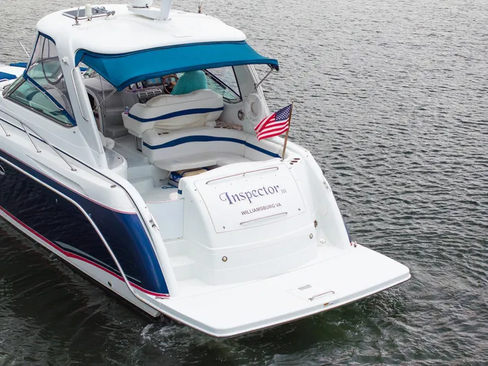  Yacht Photos Pics 2008 Formula 40 Performance Cruiser on water, featuring blue canopy and American flag.