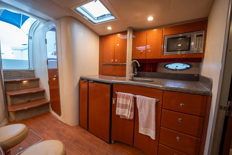  Yacht Photos Pics 2008 Formula 40 Performance Cruiser interior with modern kitchen, wood cabinets, and compact appliances.