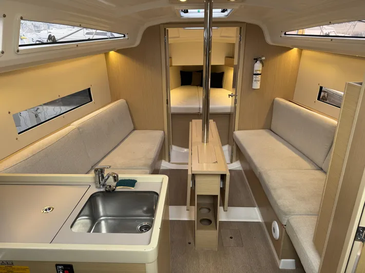 Stinger Yacht Photos Pics Interior of 2022 Beneteau Oceanis 30.1 sailboat with modern kitchen and seating area.