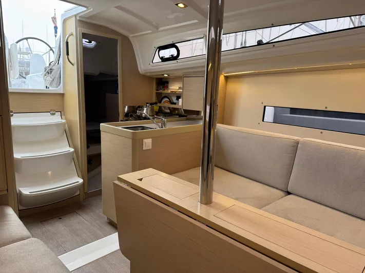 Stinger Yacht Photos Pics Interior of 2022 Beneteau Oceanis 30.1 yacht, featuring modern kitchen and cozy seating area.