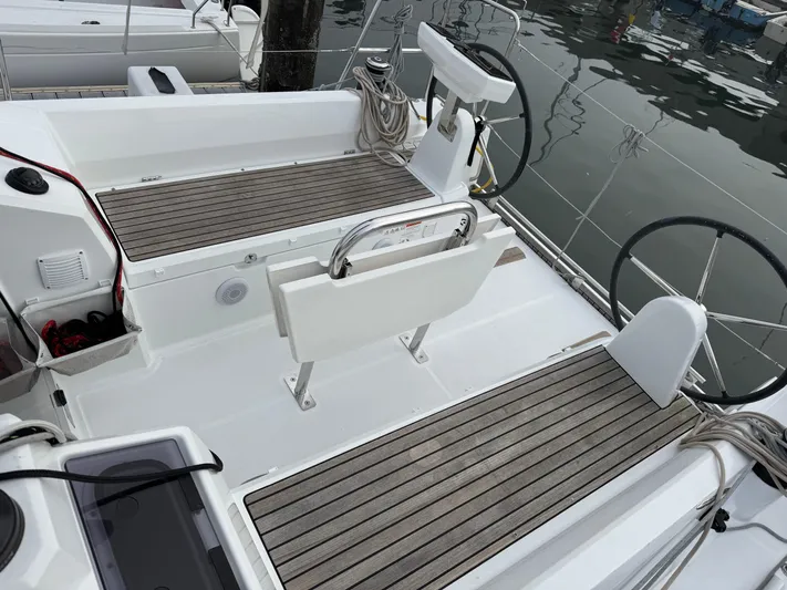 Stinger Yacht Photos Pics 2022 Beneteau Oceanis 30.1 yacht cockpit with dual steering wheels and teak flooring.