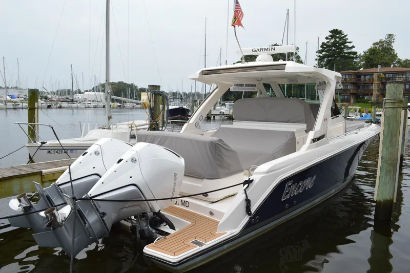 Encore Yacht Photos Pics 2023 Tiara Yachts 34 LS docked, featuring dual outboard engines and sleek design.
