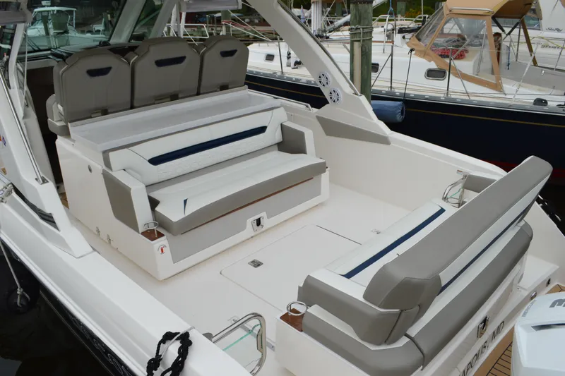 Encore Yacht Photos Pics 2023 Tiara Yachts 34 LS luxury boat interior with cushioned seating and sleek design.