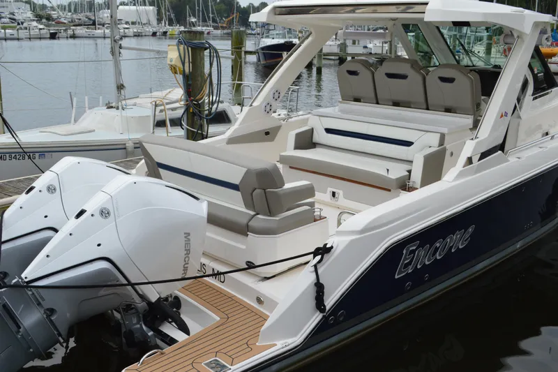 Encore Yacht Photos Pics 2023 Tiara Yachts 34 LS with dual Mercury engines docked at a marina.