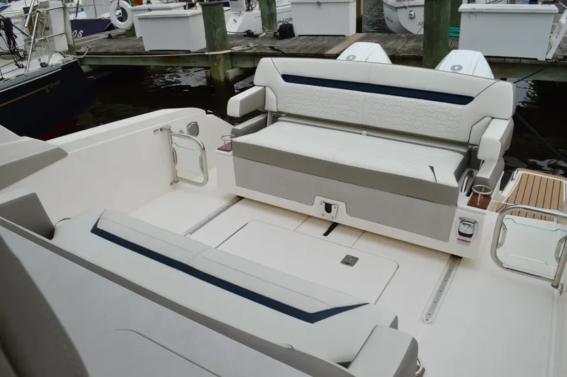 Encore Yacht Photos Pics 2023 Tiara Yachts 34 LS interior with white seating and dock view.
