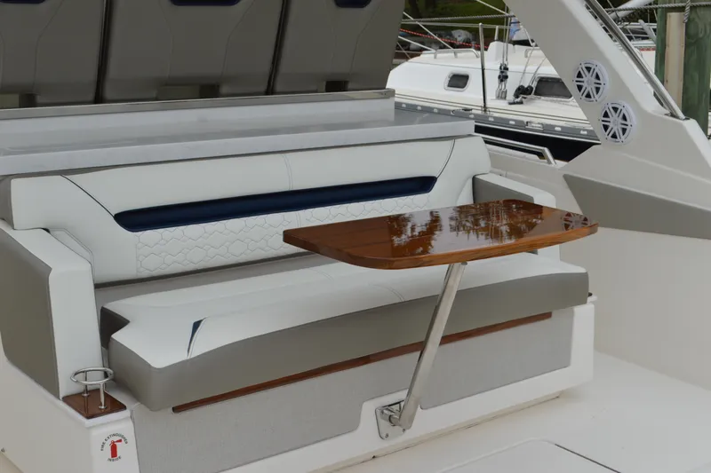 Encore Yacht Photos Pics 2023 Tiara Yachts 34 LS interior with elegant seating and wooden table.