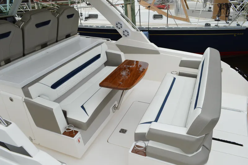 Encore Yacht Photos Pics 2023 Tiara Yachts 34 LS interior with elegant seating and wooden table.