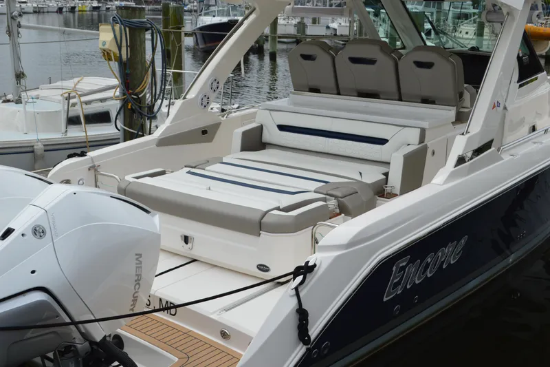 Encore Yacht Photos Pics 2023 Tiara Yachts 34 LS luxury boat docked, featuring spacious seating and dual Mercury engines.