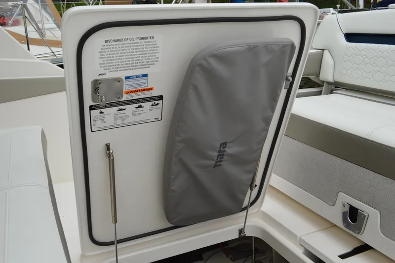 Encore Yacht Photos Pics 2023 Tiara Yachts 34 LS interior detail with storage compartment and safety warnings.