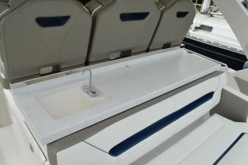 Encore Yacht Photos Pics 2023 Tiara Yachts 34 LS interior with sleek sink and seating area.