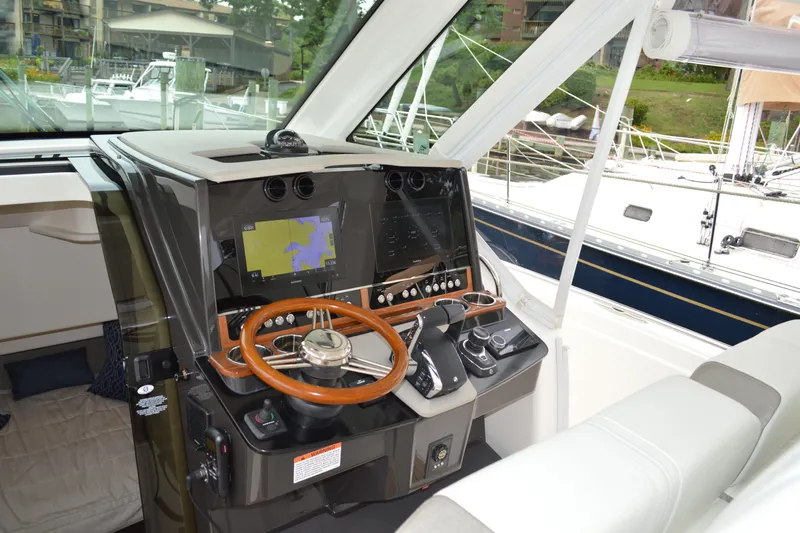 Encore Yacht Photos Pics 2023 Tiara Yachts 34 LS helm with navigation display and wooden steering wheel.