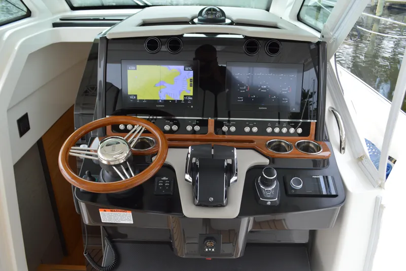 Encore Yacht Photos Pics 2023 Tiara Yachts 34 LS helm with dual displays and wooden steering wheel.