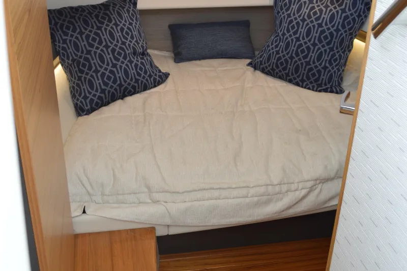 Encore Yacht Photos Pics 2023 Tiara Yachts 34 LS cabin with cozy bedding and decorative pillows.