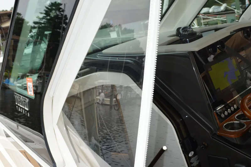 Encore Yacht Photos Pics 2023 Tiara Yachts 34 LS cockpit with navigation display and sleek design.