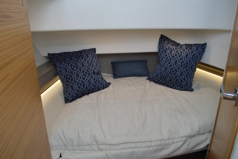 Encore Yacht Photos Pics Cozy cabin interior of 2023 Tiara Yachts 34 LS with decorative pillows.