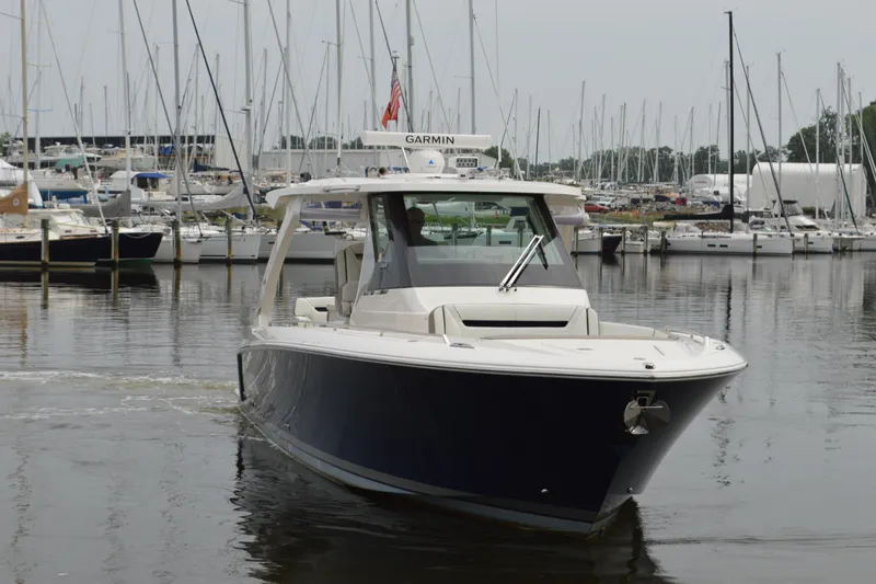 Encore Yacht Photos Pics 2023 Tiara Yachts 34 LS in marina, surrounded by sailboats.