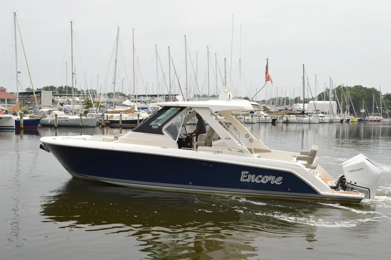 Encore Yacht Photos Pics 2023 Tiara Yachts 34 LS boat in marina, side view, with "Encore" name.