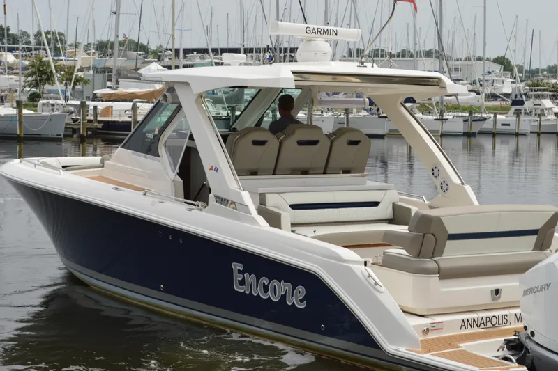 Encore Yacht Photos Pics 2023 Tiara Yachts 34 LS boat docked in marina, featuring sleek design and luxury seating.