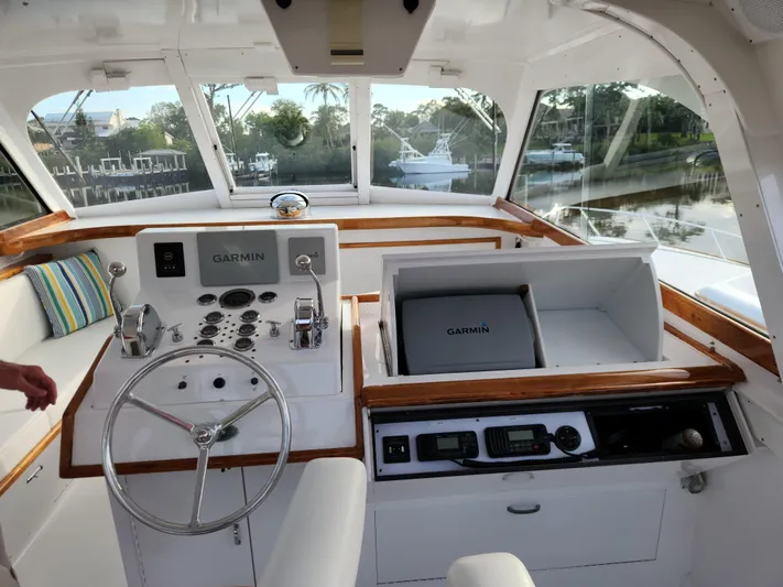 Miss Phebe II Yacht Photos Pics 1971 Whiticar Sportfish boat interior with Garmin navigation system and wooden accents.