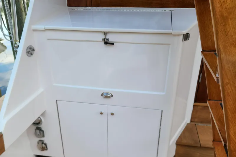 Miss Phebe II Yacht Photos Pics 1971 Whiticar Sportfish boat interior with white storage cabinet and wooden stairs.