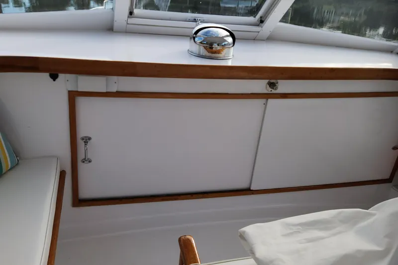 Miss Phebe II Yacht Photos Pics 1971 Whiticar Sportfish interior with wooden trim and storage compartment.