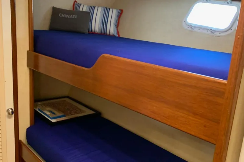 Miss Phebe II Yacht Photos Pics Bunk beds in a 1971 Whiticar Sportfish boat cabin with blue bedding.