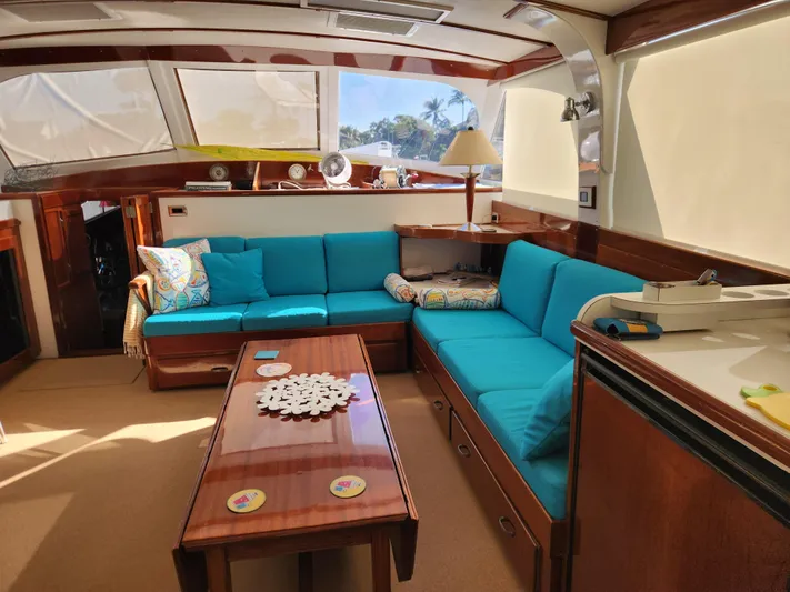 Miss Phebe II Yacht Photos Pics Interior of a 1971 Whiticar Sportfish yacht with blue seating and wooden accents.