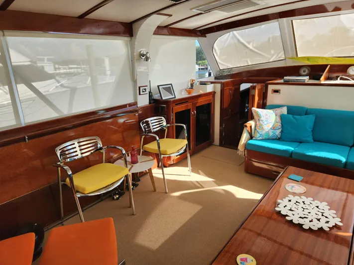 Miss Phebe II Yacht Photos Pics Interior of a 1971 Whiticar Sportfish yacht with modern seating and wooden accents.