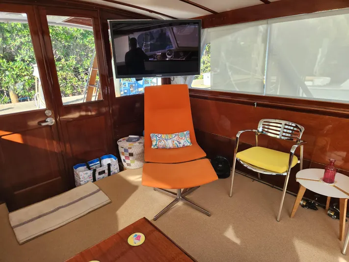 Miss Phebe II Yacht Photos Pics Interior of 1971 Whiticar Sportfish with modern seating and wall-mounted TV.