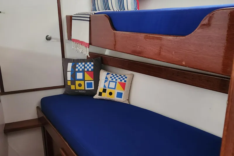 Miss Phebe II Yacht Photos Pics Interior of a 1971 Whiticar Sportfish with blue cushions and nautical-themed pillows.