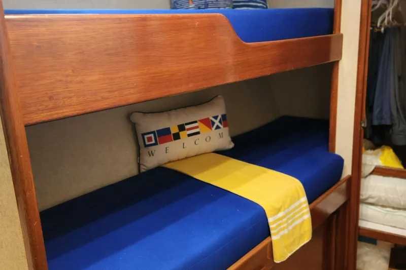 Miss Phebe II Yacht Photos Pics Bunk beds with blue cushions in a 1971 Whiticar Sportfish boat cabin.