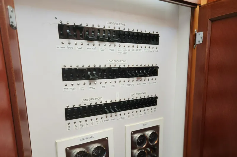 Miss Phebe II Yacht Photos Pics Electrical panel of a 1971 Whiticar Sportfish boat with labeled switches and gauges.