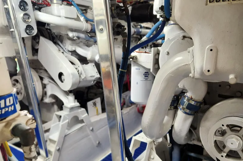 Miss Phebe II Yacht Photos Pics Engine room of a 1971 Whiticar Sportfish boat, showcasing mechanical components and piping.