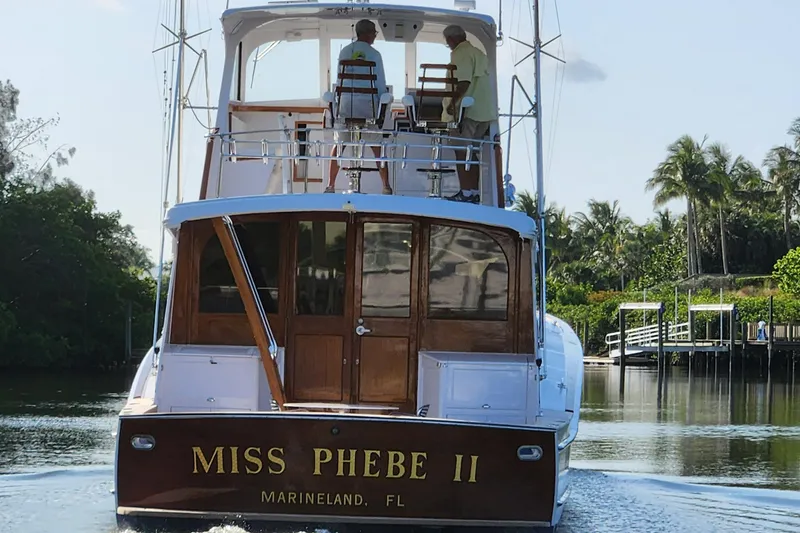 Miss Phebe II Yacht Photos Pics 1971 Whiticar Sportfish boat "Miss Phebe II" cruising in a serene waterway.
