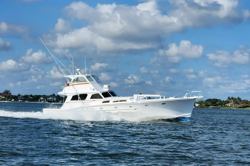  Yacht Photos Pics 1971 Whiticar Sportfish yacht cruising on open water under a partly cloudy sky.