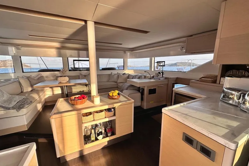  Yacht Photos Pics Luxurious interior of 2021 Lagoon 50 catamaran with modern kitchen and seating area.