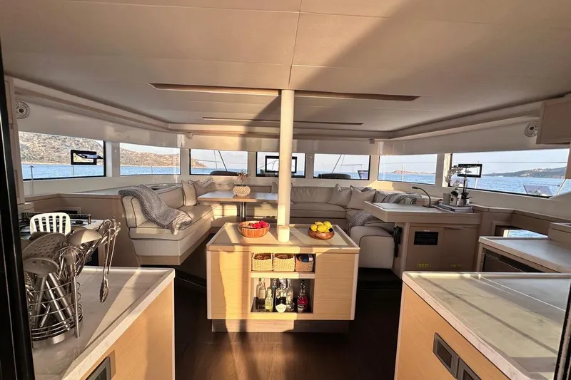  Yacht Photos Pics Luxurious interior of 2021 Lagoon 50 yacht with panoramic windows and elegant furnishings.
