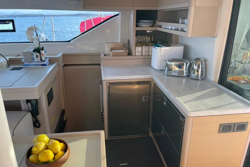  Yacht Photos Pics Modern kitchen interior on 2021 Lagoon 50 yacht with sea view and sleek appliances.