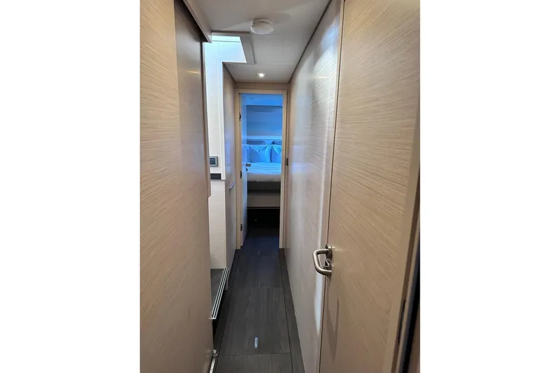  Yacht Photos Pics Interior hallway of 2021 Lagoon 50 yacht, featuring modern design and wood finishes.