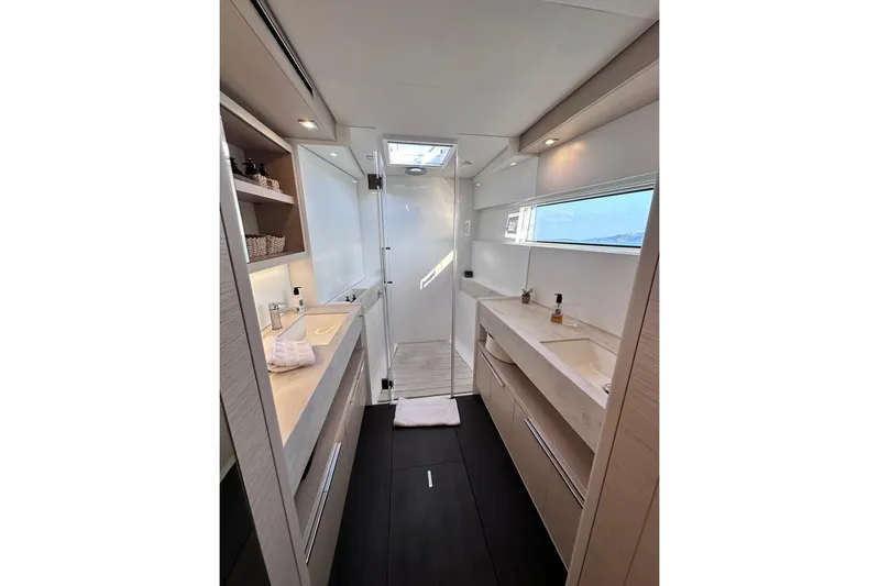  Yacht Photos Pics Luxurious bathroom interior of 2021 Lagoon 50 yacht with modern fixtures and ample lighting.