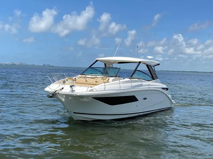 2023 Sea Ray Sundancer 320 @ Imp Def Yacht Photos Pics 2023 Sea Ray Sundancer 320 cruising on a sunny day with clear skies.
