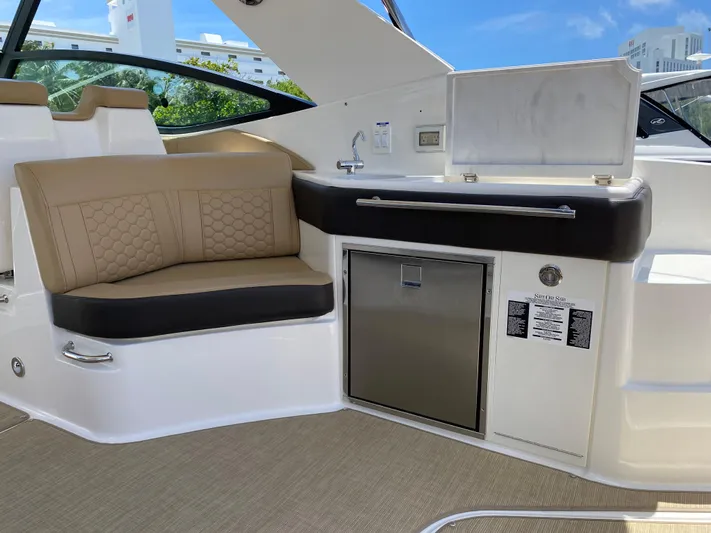2023 Sea Ray Sundancer 320 @ Imp Def Yacht Photos Pics 2023 Sea Ray Sundancer 320 interior with seating, kitchenette, and stainless steel appliances.