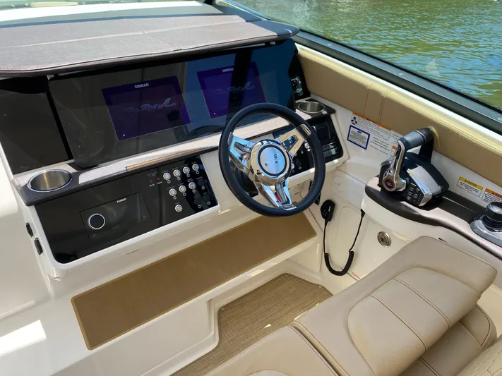 2023 Sea Ray Sundancer 320 @ Imp Def Yacht Photos Pics 2023 Sea Ray Sundancer 320 helm with modern controls and dual displays.