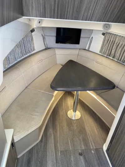 2023 Sea Ray Sundancer 320 @ Imp Def Yacht Photos Pics 2023 Sea Ray Sundancer 320 cabin interior with seating and table.