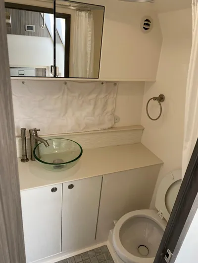 2023 Sea Ray Sundancer 320 @ Imp Def Yacht Photos Pics Modern bathroom in 2023 Sea Ray Sundancer 320 yacht with glass sink and sleek fixtures.