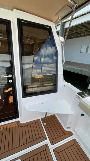  Yacht Photos Pics 2026 Ranger Tugs R-27 boat interior with wood flooring and large window.