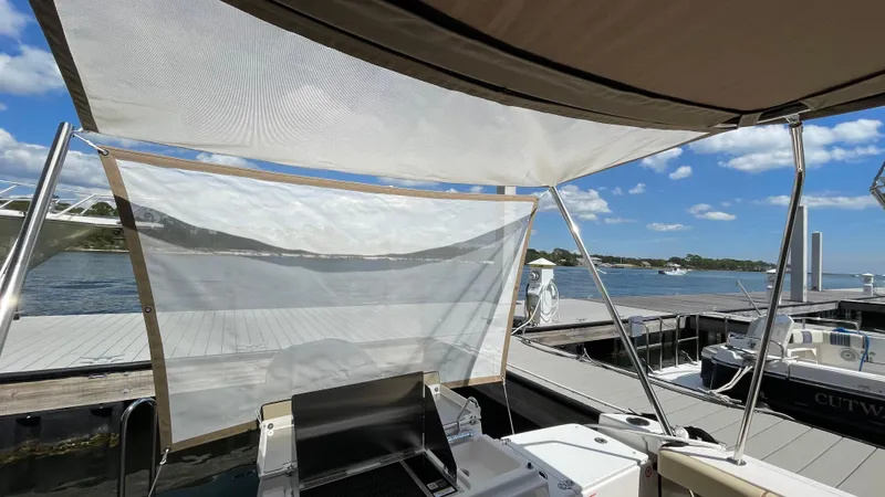  Yacht Photos Pics 2026 Ranger Tugs R-27 at dock, featuring canopy and scenic waterfront view.