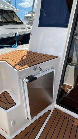 Yacht Photos Pics 2026 Ranger Tugs R-27 boat deck with wood finish and storage compartment.
