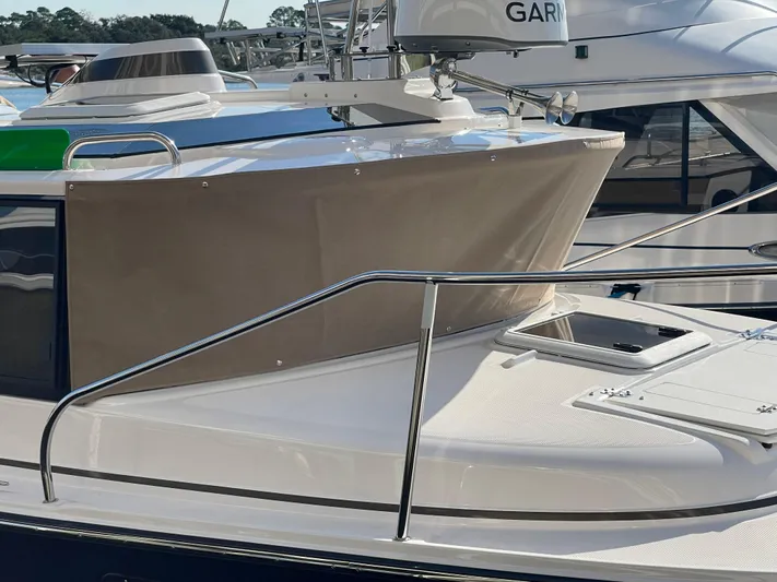  Yacht Photos Pics 2026 Ranger Tugs R-27 boat deck with railing and hatch, featuring Garmin equipment.