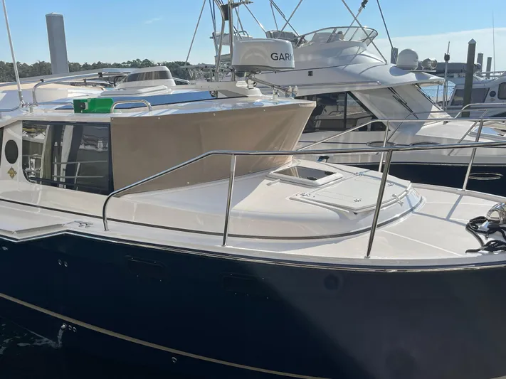  Yacht Photos Pics 2026 Ranger Tugs R-27 boat docked at marina, featuring sleek design and modern amenities.